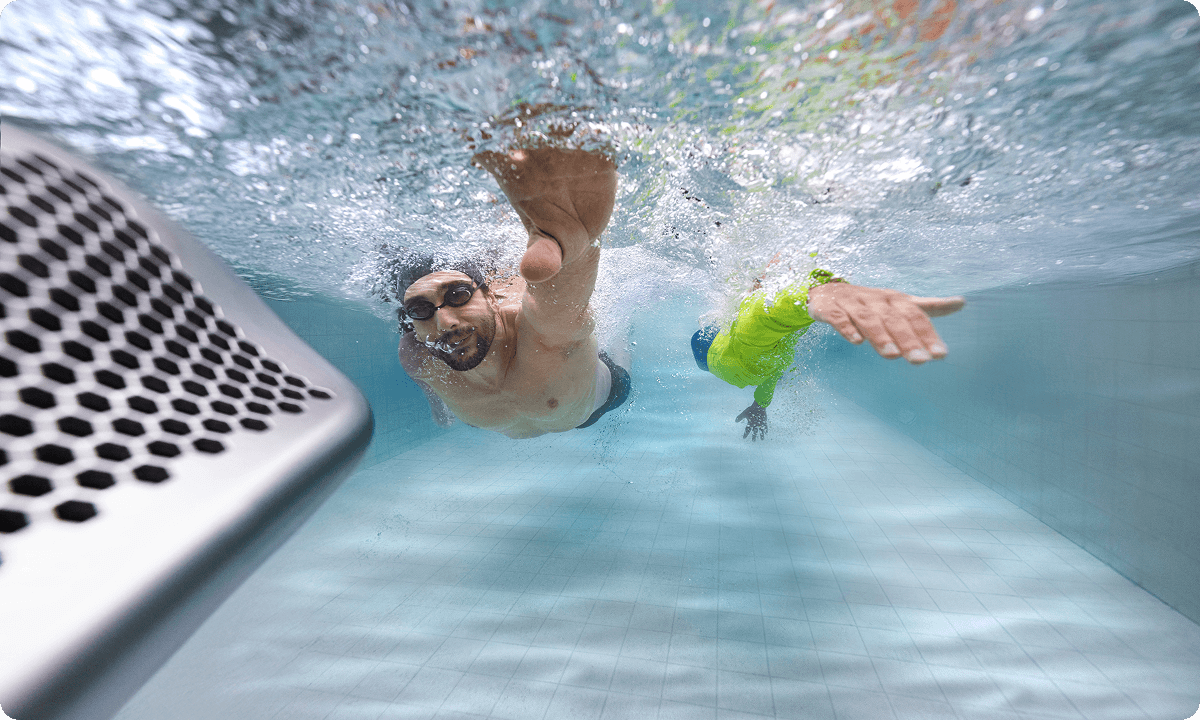Swimmers engaging in high-intensity freestyle swimming resistance training with the iGarden Swim Jet P Series