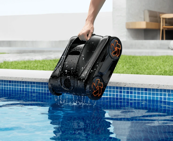 Person easily lifting the lightweight iGarden Pool Cleaner K Series from the water